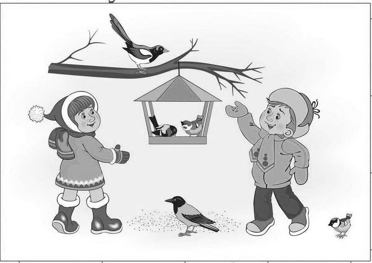 Ласковые дети кормят птиц зимой у кормушки