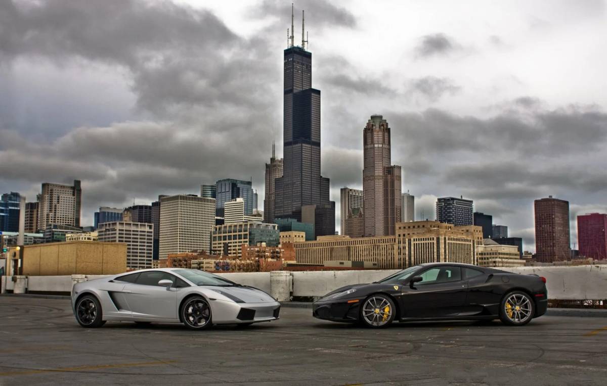Городские автомобили сайты. Ламборгини в Нью Йорке. Lamborghini Ferrari Black. Автомобиль и небоскрёбы. Автомобиль на фоне небоскребов.